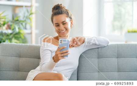 Young woman is using phone for video call 69925893