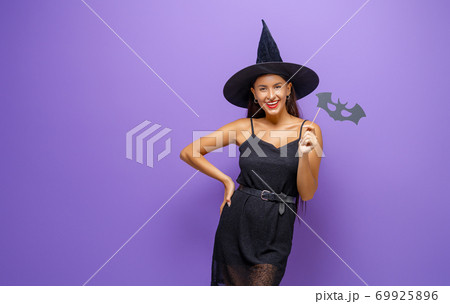 woman in black witch costume 69925896