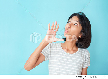 Asian girl expression excited on face on the background blue isolated 69928008