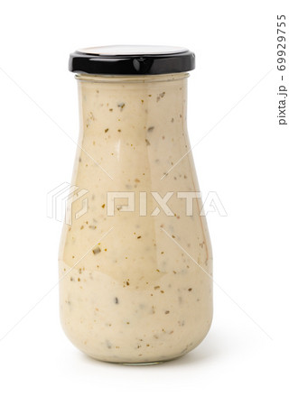 Closed glass jar of white garlic and herb sauce Closed glass jar of white garlic and herb sauce 69929755