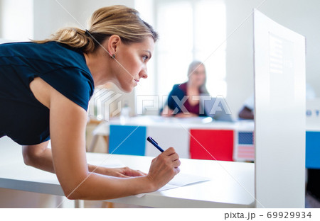 Portrait of woman voter in polling place, usa elections concept. 69929934