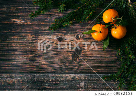tangerines and fir branches on wooden Christmas background 69932153