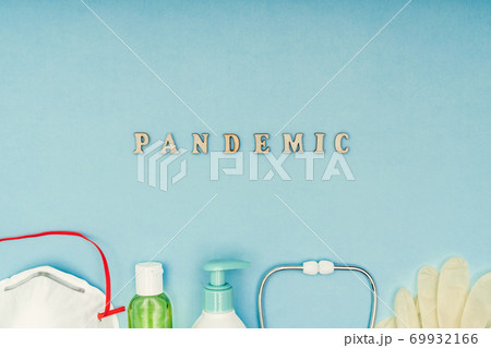 Coronavirus, Covid-19. The inscription Pandemic, a protective mask, antiseptic and dispenser for soap soap on a blue background. Self-isolation and quarantine, personal protective equipment. 69932166