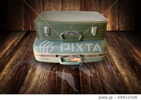 Vintage travel bag on wooden floor Vintage travel bag on wooden floor 69932506