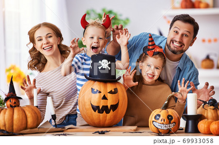 Delighted family during Halloween celebration. 69933058