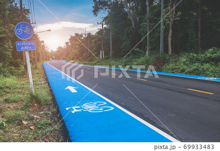 Asphalt road with blue side pavement for bicycle lane. Asphalt road with blue side pavement for bicycle lane. 69933483