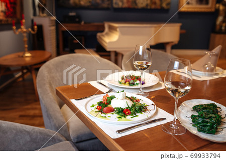 Restaurant table served with spanish salads 69933794