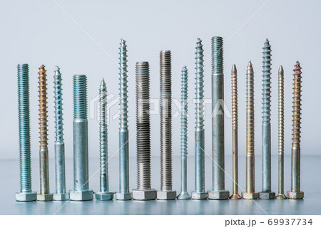 Row of steel bolt and screws in workshop 69937734