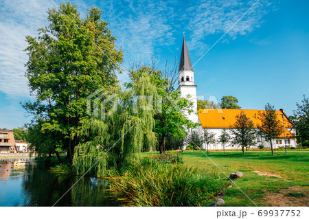 Sigulda Evangelic Lutheran Church with green trees in Sigulda, Latvia Sigulda Evangelic Lutheran Church with green trees in Sigulda, Latvia 69937752