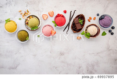 Various of ice cream  flavours in bowl blueberry ,green tea ,coconut ,strawberry and chocolate  setup on white stone background . 69937895