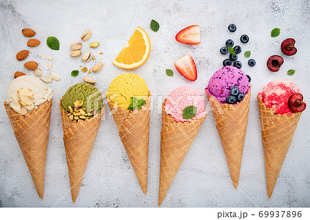 Various of ice cream flavor in cones blueberry ,pistachio ,almond ,orange and cherry setup on white stone background . Summer and Sweet menu concept. 69937896