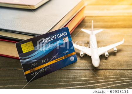 Credit card and airplane model on wooden table Credit card and airplane model on wooden table 69938151