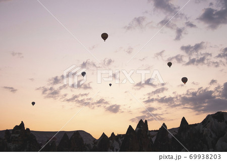 Flying balloons against the background of the colored dawn sky Flying balloons against the background of the colored dawn sky 69938203
