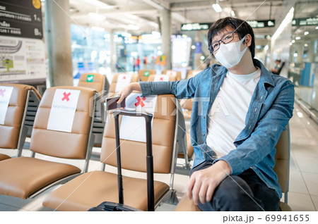 Asian man tourist wearing mask in airport terminal 69941655
