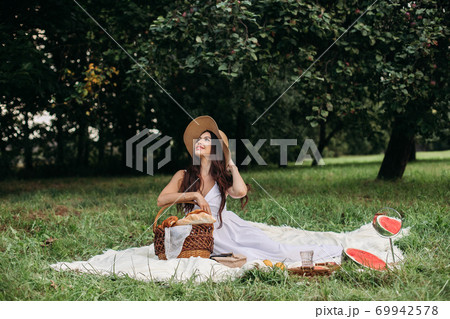 Beautiful Caucasian woman at picnic. Full length Beautiful Caucasian woman at picnic. Full length 69942578