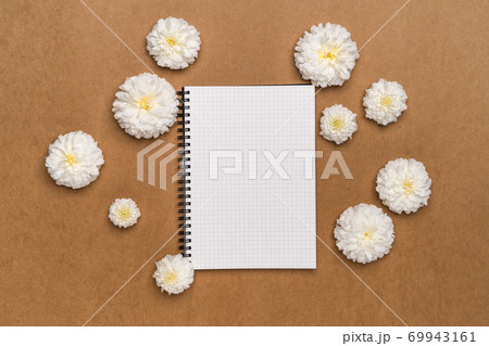 Notebooks and flowers-  notebook and white flowers on brown paper 69943161
