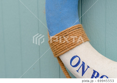 Life buoy with on board text decorate on wooden wall 69945553