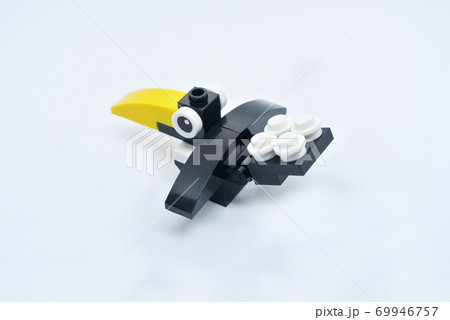 The shape of a crow is made of colorful plastic toy blocks. 69946757