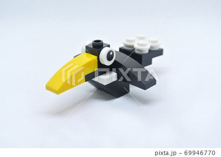 The shape of a crow is made of colorful plastic toy blocks. 69946770