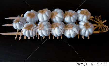 Fresh harvesting garlic tied in bunches. Dried decorative garlic on the dark background 69949399