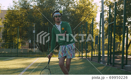 Funny freak man playing tennis ball 69950226