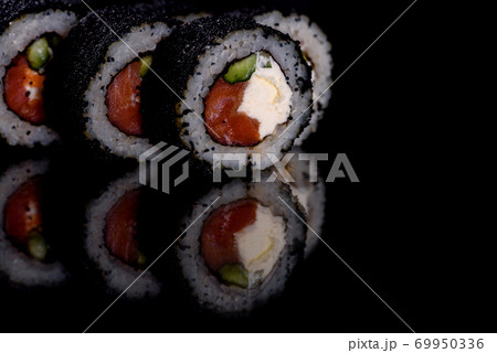 Fresh delicious beautiful sushi rolls on a dark background 69950336