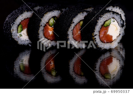 Fresh delicious beautiful sushi rolls on a dark background 69950337