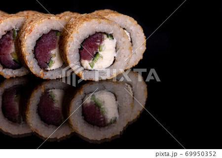 Fresh delicious beautiful sushi rolls on a dark background 69950352
