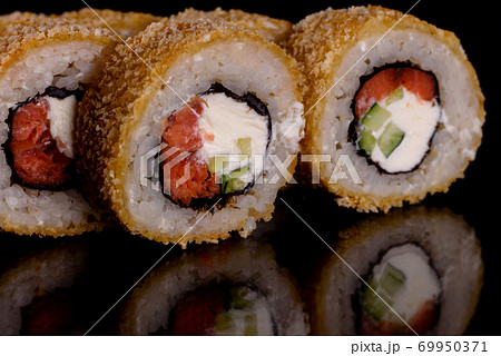 Fresh delicious beautiful sushi rolls on a dark background Fresh delicious beautiful sushi rolls on a dark background 69950371
