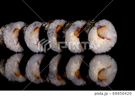 Fresh delicious beautiful sushi rolls on a dark background Fresh delicious beautiful sushi rolls on a dark background 69950420
