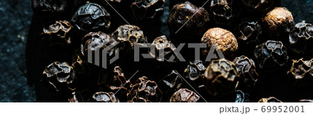 Black pepper closeup on luxury stone background as flat lay, dry food spices and recipe ingredient Black pepper closeup on luxury stone background as flat lay, dry food spices and recipe ingredient 69952001