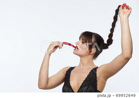 beautiful girl posing with red chili peppers. Studio, White background 69952649