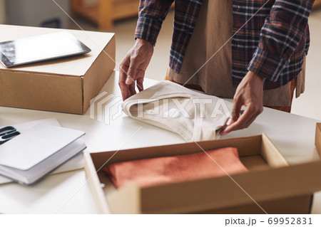 Man packing new clothes Man packing new clothes 69952831