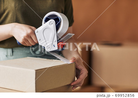 Woman packing packages Woman packing packages 69952856