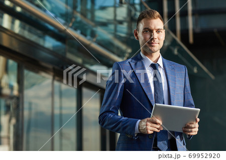 Businessman with digital tablet outdoors Businessman with digital tablet outdoors 69952920