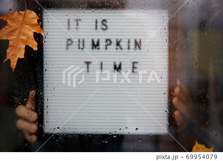 Letter board though the window with wet leaves and raindrops Letter board though the window with wet leaves and raindrops 69954079
