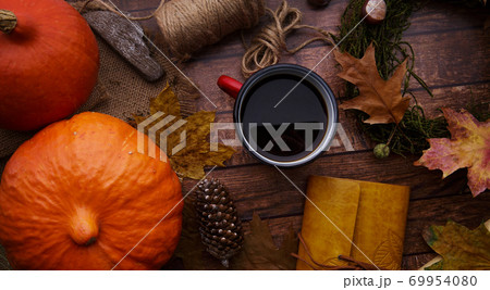 on the table a mug of coffee pumpkin and decoration on the table a mug of coffee pumpkin and decoration 69954080