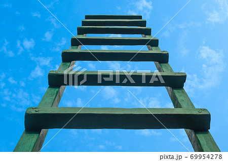 Reaching For Green Ladder Leading To A Blue Sky Reaching For Green Ladder Leading To A Blue Sky 69954278