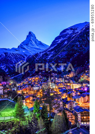 View of old village in twilight time with Matterhorn peak background in Zermatt, Switzerland. View of old village in twilight time with Matterhorn peak background in Zermatt, Switzerland. 69955280