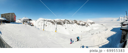 Skier skiing downhill in high mountains in Piz Gloria at Switzerland Skier skiing downhill in high mountains in Piz Gloria at Switzerland 69955383