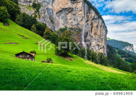Fabulous Lauterbrunnen alpine village and Staubbach waterfall in background, Switzerland Fabulous Lauterbrunnen alpine village and Staubbach waterfall in background, Switzerland 69961909