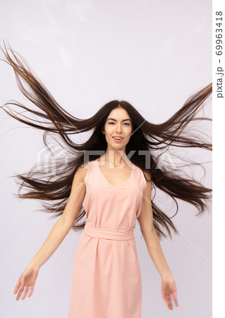 Young woman with long hair. Brunette Young woman with long hair. Brunette 69963418