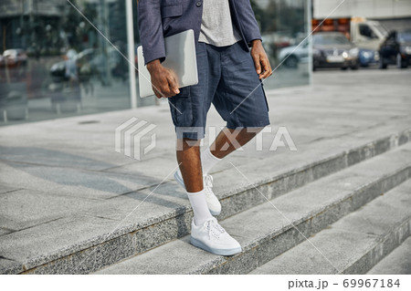 Close up of international man walking downstairs 69967184