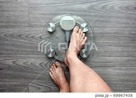 Human feet on electronic scales Human feet on electronic scales 69967438