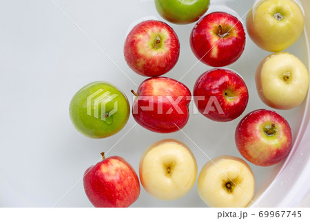 Washing fresh apples in the water 69967745
