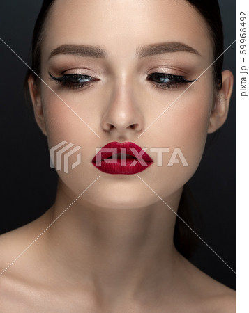 Portrait of young beautiful woman with red lips Portrait of young beautiful woman with red lips 69968492