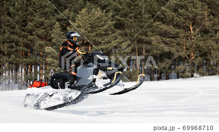 In deep powder snowdrift snowmobile rider driving fast. In deep powder snowdrift snowmobile rider driving fast. 69968710