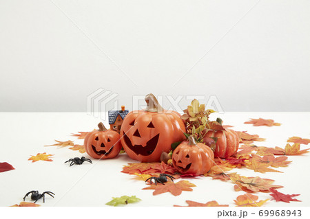 Halloween decorate pumpkins with autumn leaves 69968943