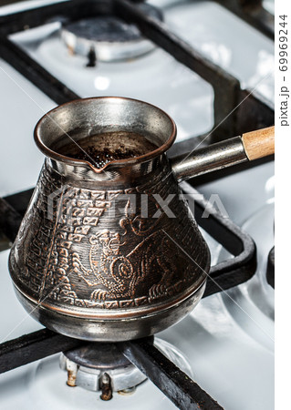 Copper coffeepot on the gas stove at home 69969244