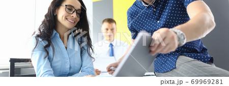 Successful business team are discussing new strategies in office on laptop Successful business team are discussing new strategies in office on laptop 69969281